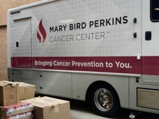 Cancer center staff distributes hundreds of meal boxes to patients for the holidays