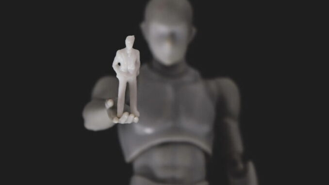 A robot holding a figure of a man - Source AutoGPT
