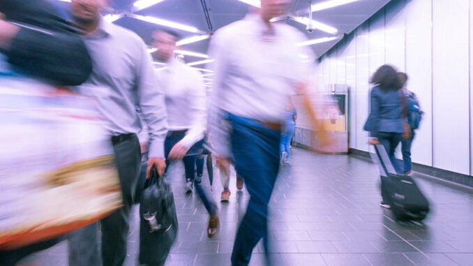 People rushing on a subway platform - Unsplash