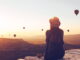 A person looking at hot air balloons - Source Cendyn
