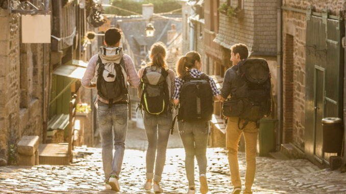 4 back packers on a street