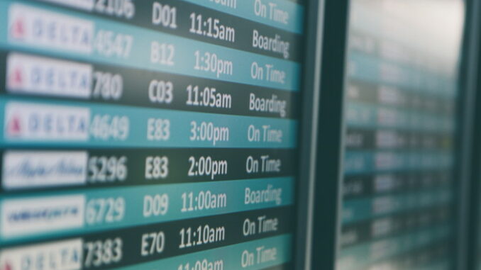 Airport departures timetable showing Delta and Alaska Airlines flights on time and boarding - Photo by Matthew Smith on Unsplash