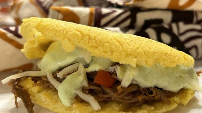 At The Table: From Venezuela to Lafayette, David Gomez makes arepas with carne mechada